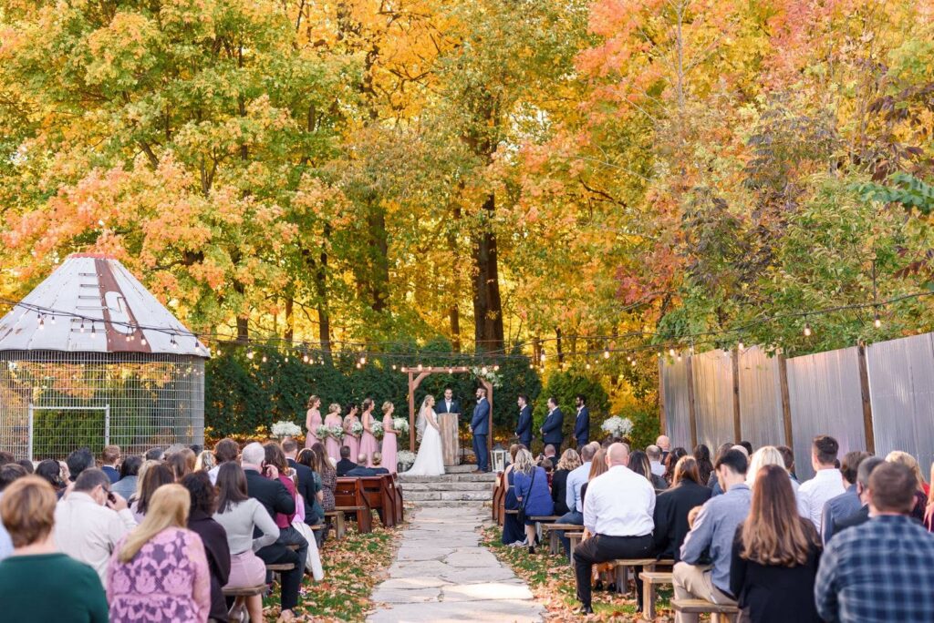 Wedding guests attend a fall wedding at an outdoor wedding venue near Milwaukee