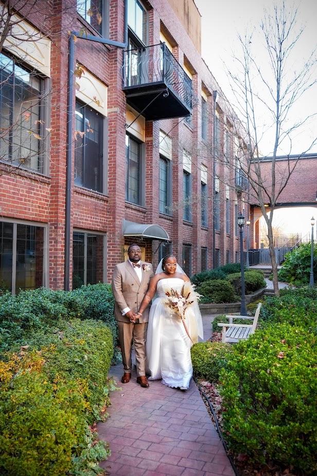 Bride and groom posing for wedding photos at The Event at Two Ten in Kernersville, North Carolina