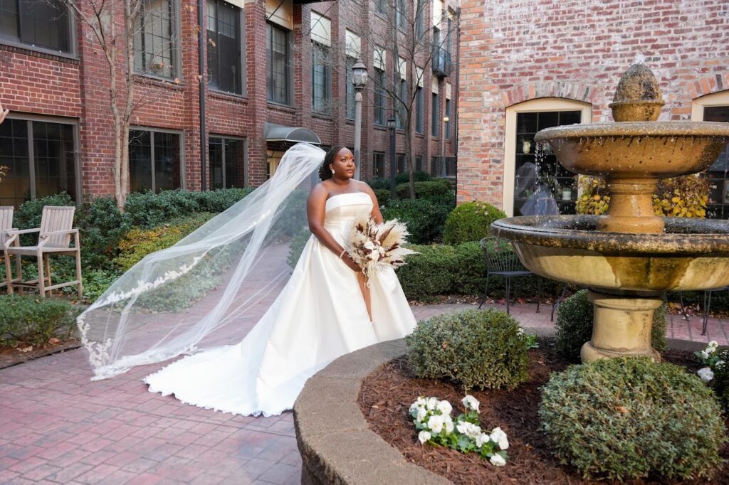 Beautiful bride posing for wedding day photos at a garden courtyard wedding venue near Winston Salem NC