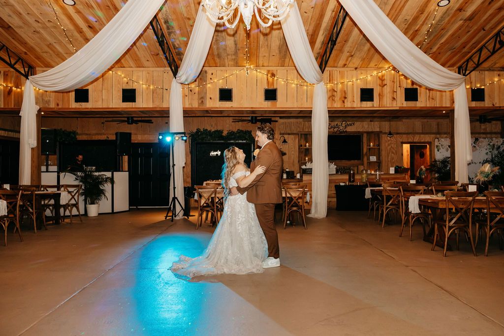 Bride & Groom celebrating their wedding at Rustic Grace Barn near ChampionsGate Florida