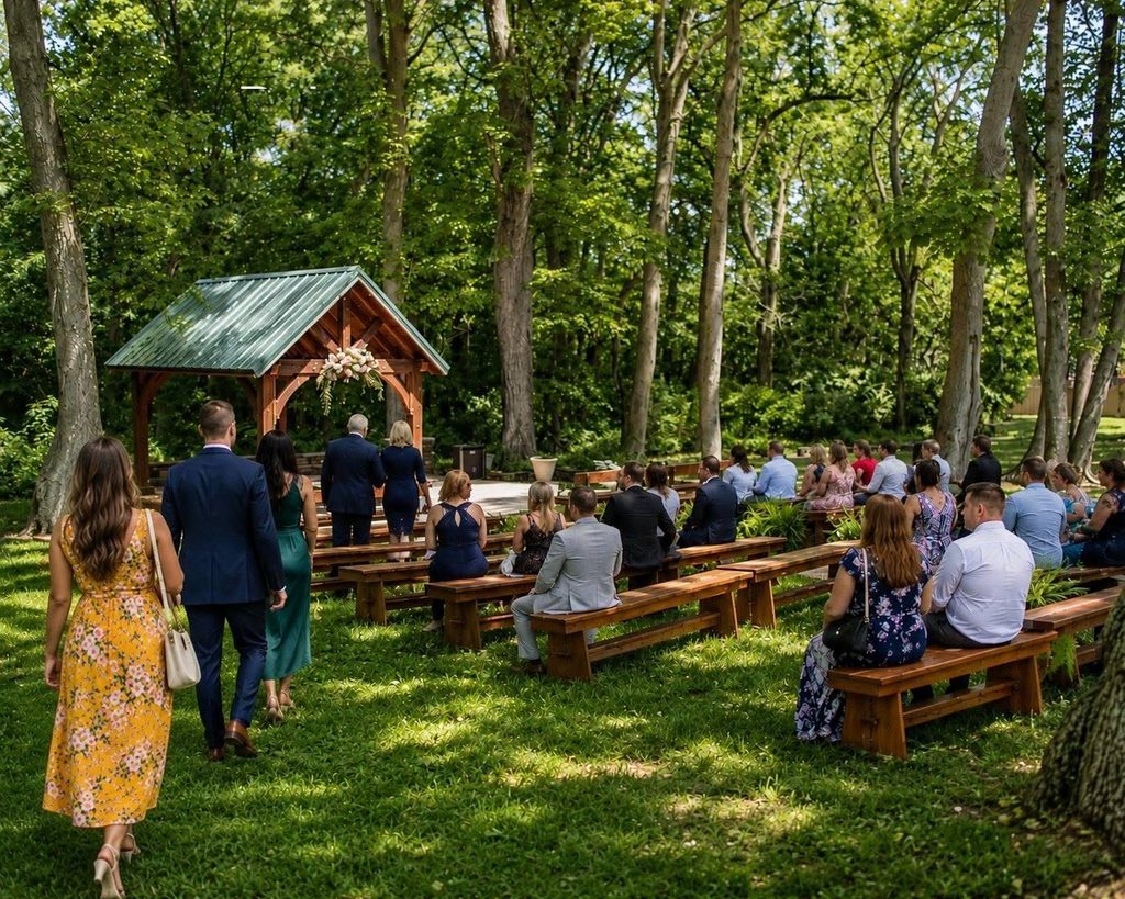 Outdoor wedding ceremony setting surrounded by mature trees in Middletown DE