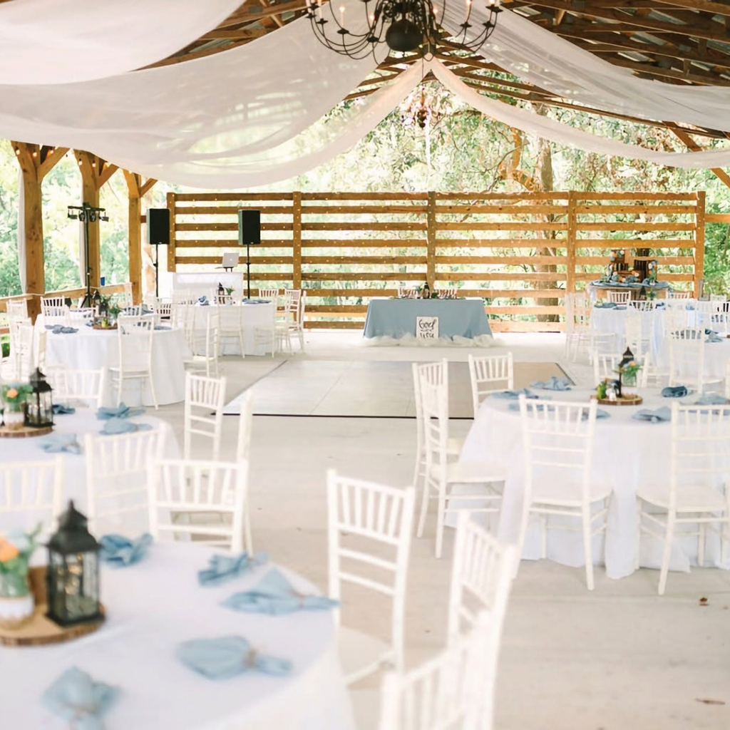 Outdoor covered wedding reception barn with chandeliers at All 4 One Farms featuring luxury 
